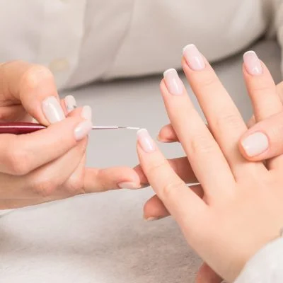 woman-receiving-french-manicure-by-beautician-1-scaled-e1722530934569-qrz74sth6nlkvth57yf89mbgc0rv8yhfvqn6fbuso0